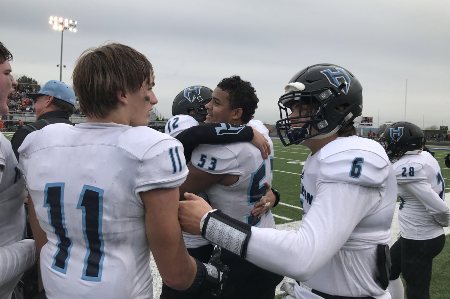 The Hockinson Hawks, including Kordell Johnson (53) and Canon Racanelli celebrate the team's 53-30 victory Saturday over West Valley of Spokane.