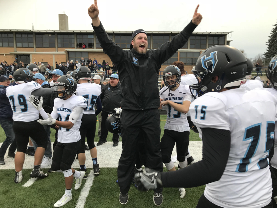 Hockinson assistant football coach Hayden Pinkle celebrates the Hawks' 53-30 victory over West Valley of Spokane on Saturday at Gonzaga Prep High School. The Hawks advance to next weekend's 2A state title game against Tumwater at the Tacoma Dome.