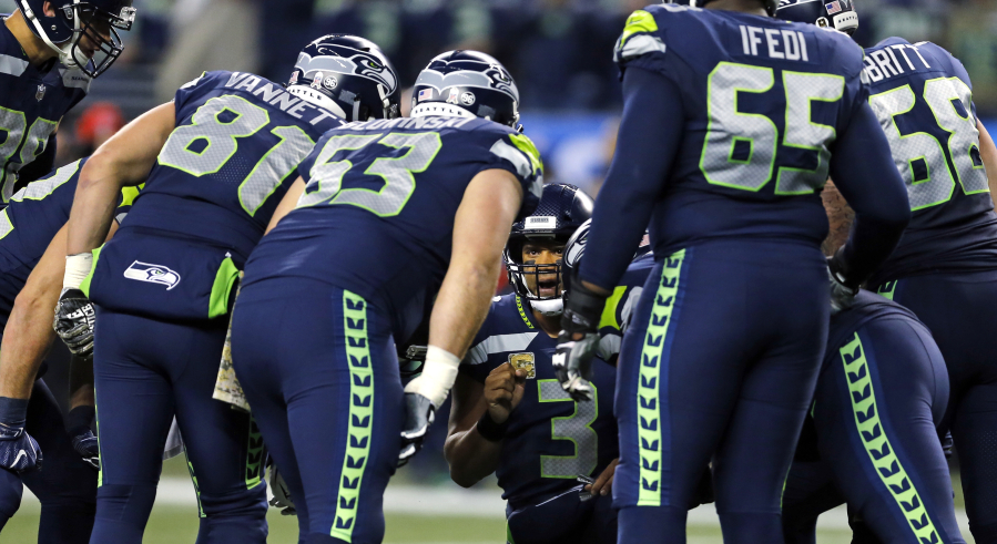Seattle Seahawks quarterback Russell Wilson (3) leads his team in a huddle against the Atlanta Falcons in the first half of an NFL football game, Monday, Nov. 20, 2017, in Seattle.