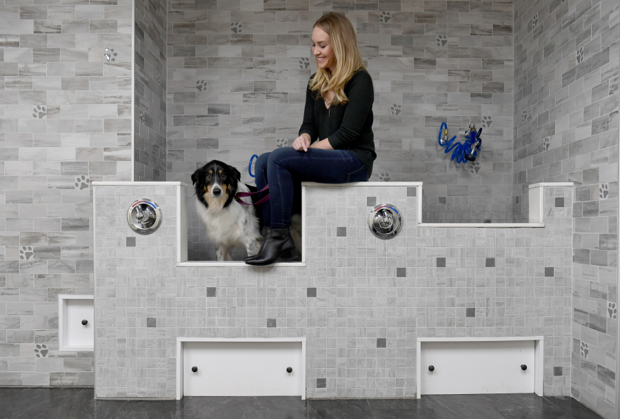One of the selling points that appealed to Laura Kiker is that there is a dog wash area in the basement of the apartment building where she poses with Stella in November; there is also a yoga studio and rooftop deck. MUST CREDIT: Washington Post photo by Katherine Frey.