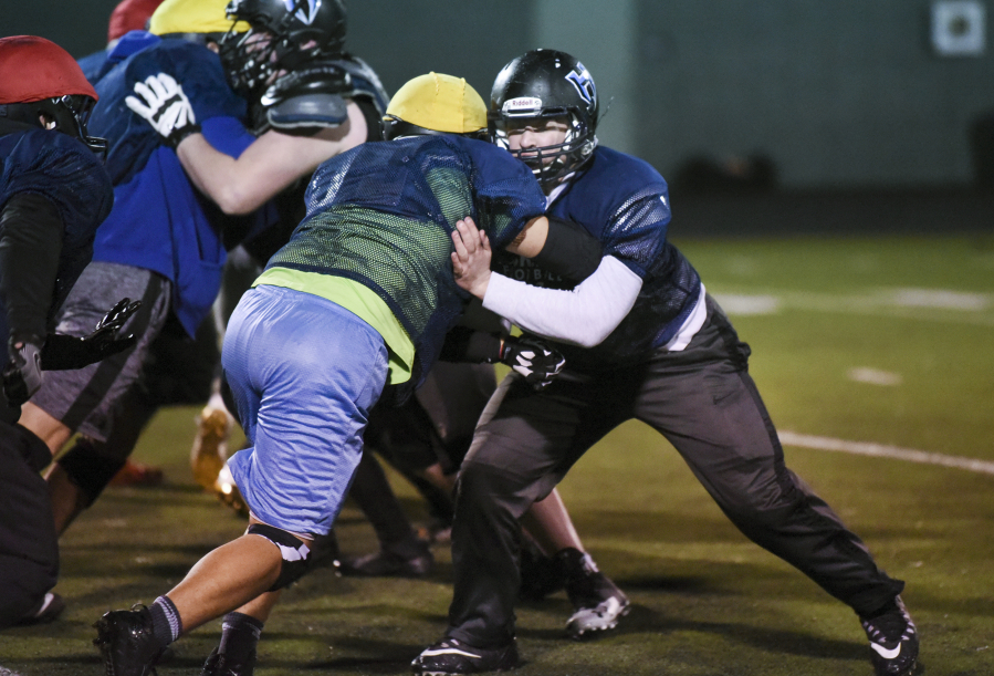 Hockinson’s offensive tackle Ryan Sleasman, right, has been part of every postseason run in the past three seasons with the Hawks.