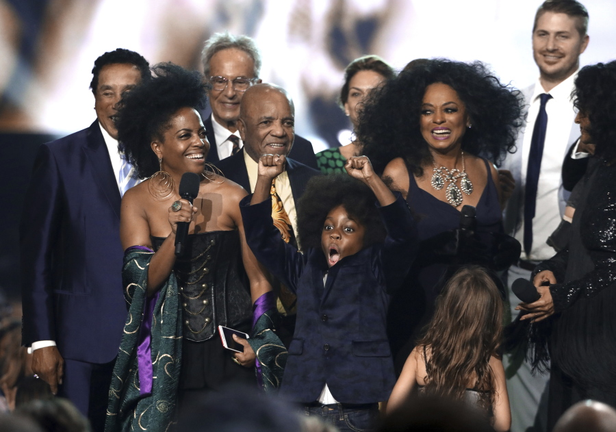 Rhonda Ross Kendrick, from left, speaks and her son Raif-Henok Emmanuel Kendrick reacts as Diana Ross accepts the lifetime achievement award at the American Music Awards at the Microsoft Theater on Sunday in Los Angeles.