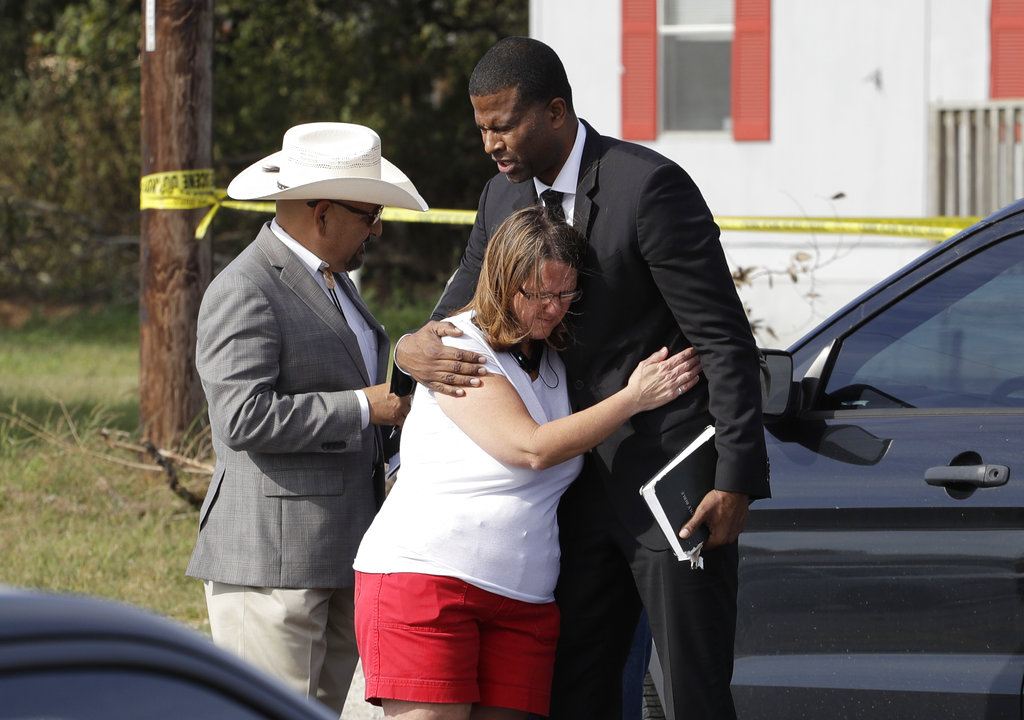 Pastor Dimas Salaberrios, right, prays with Sherri Pomeroy near the First Baptist Church of Sutherland Springs, Monday, Nov. 6, 2017, in Sutherland Springs, Texas. A man opened fire inside the church in the small South Texas community on Sunday, killing and wounding many. The Pomeroy's daugher, Annabelle, 14, was killed in the shooting.