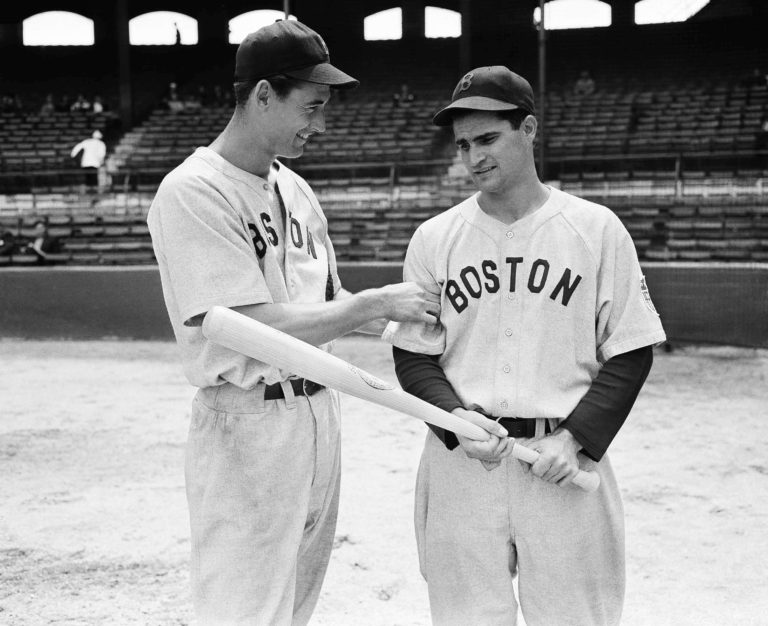 Boston Red Sox left fielder Ted Williams, left, tests the arm of Red Sox second baseman Bobby Doerr in this 1942 photo. Doerr, a Hall of Fame second baseman who was dubbed the "silent captain" by longtime Red Sox teammate and life-long friend Ted Williams, has died. He was 99.