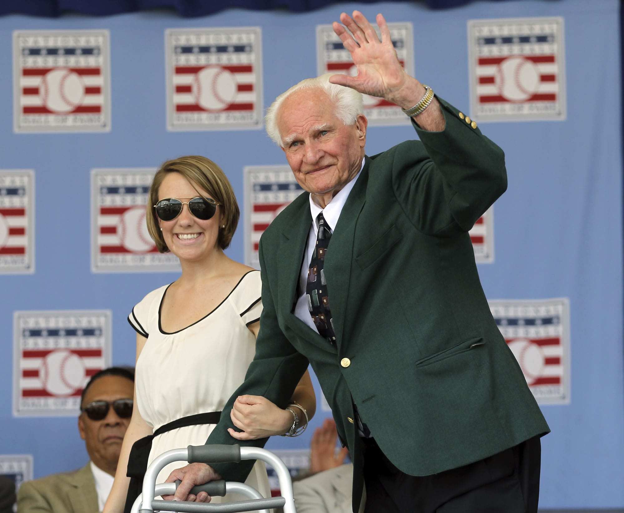 Hall of Famer Bobby Doerr waves during Baseball Hall of Fame induction ceremonies in Cooperstown, N.Y., in July 2011. Doerr, a Hall of Fame second baseman who was dubbed the "silent captain" by longtime Red Sox teammate and life-long friend Ted Williams, has died. He was 99.