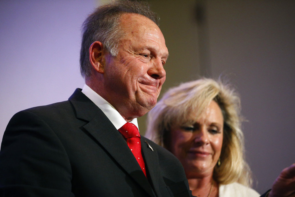Former Alabama Chief Justice and U.S. Senate candidate Roy Moore speaks at a news conference, Thursday, Nov. 16, 2017, in Birmingham, Ala., with his wife Kayla Moore, right.