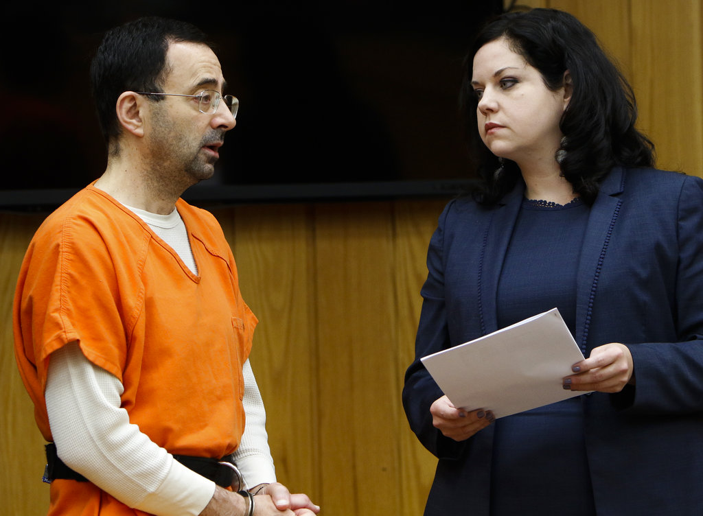 Former sports doctor Larry Nassar, left, stands with his attorney Shannon Smith as he pleads guilty to three counts of first-degree criminal sexual conduct Wednesday, Nov. 29, 2017, in Judge Janice Cunningham's courtroom in Eaton County, Mich.