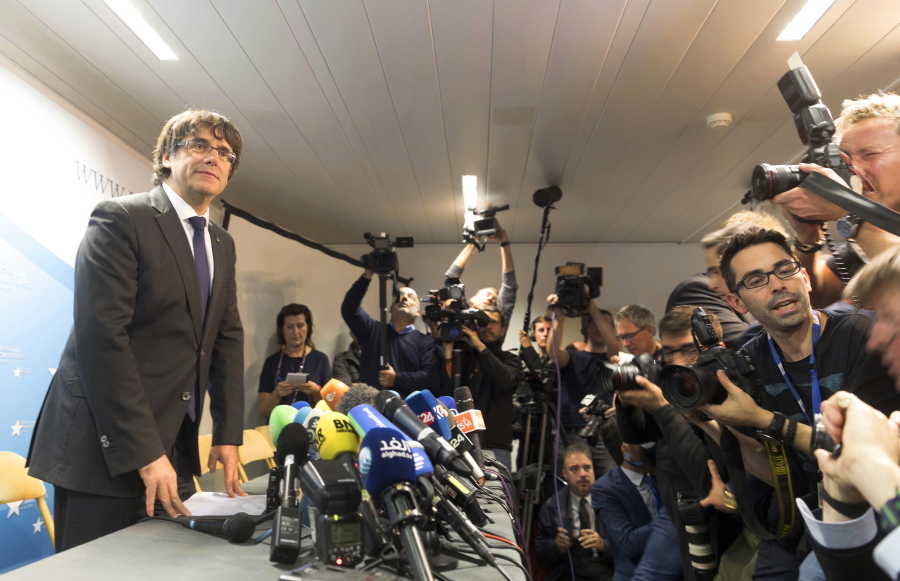 Sacked Catalonian President Carles Puigdemont looks on after a press conference in Brussels on Tuesday. Ousted Catalan President Carles Puigdemont is calling for avoiding violence and says dialogue is a priority during his first address on Belgian soil. Puigdemont on Tuesday recapped the issues which led him to leave for Belgium the previous day, but did not immediately say in his statement what he would do in Brussels or whether he would seek asylum.