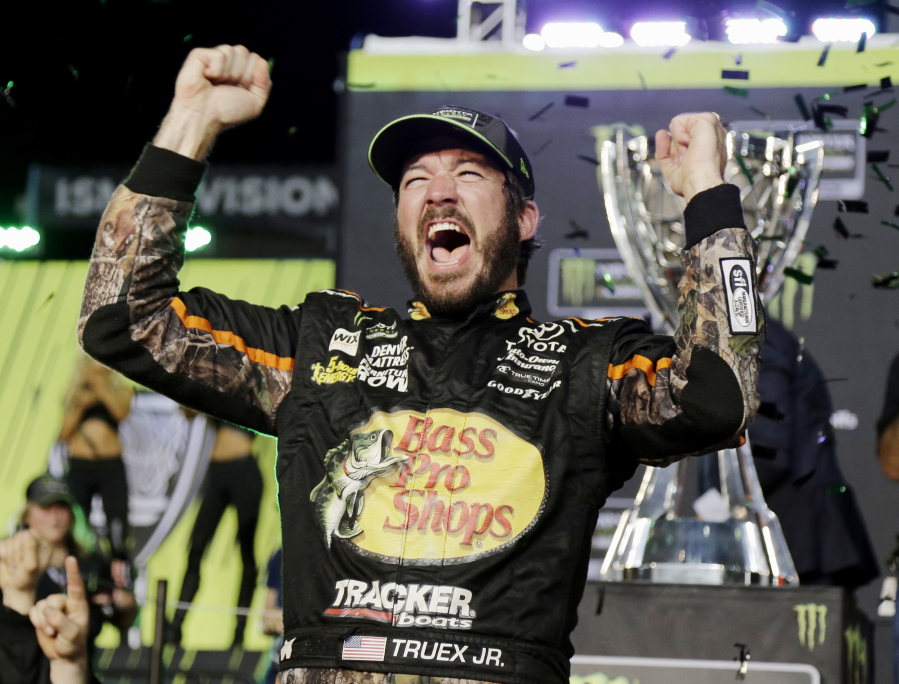 Martin Truex Jr. celebrates in Victory Lane after winning the NASCAR Cup Series auto race and season championship at Homestead-Miami Speedway in Homestead, Fla., Sunday, Nov. 19, 2017.
