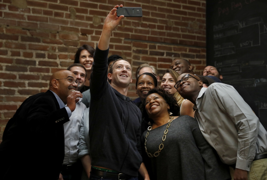 Facebook CEO Mark Zuckerberg takes a selfie with a group of entrepreneurs and innovators after taking part in a roundtable discussion at Cortex Innovation Community technology hub Thursday in St. Louis.