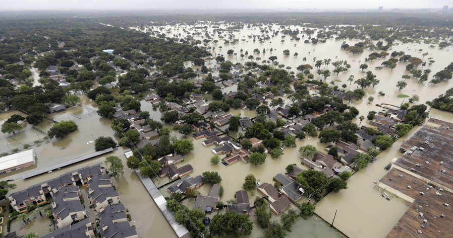 A neighborhood near Houston’s Addicks Reservoir is flooded after heavy rains from Tropical Storm Harvey. A study released Monday, Nov. 20, 2017 predicts that summer thunderstorms in North America will likely be larger, wetter and more frequent in a warmer world, dumping 80 percent more rain in some areas and worsening flooding. (AP Photo/David J.