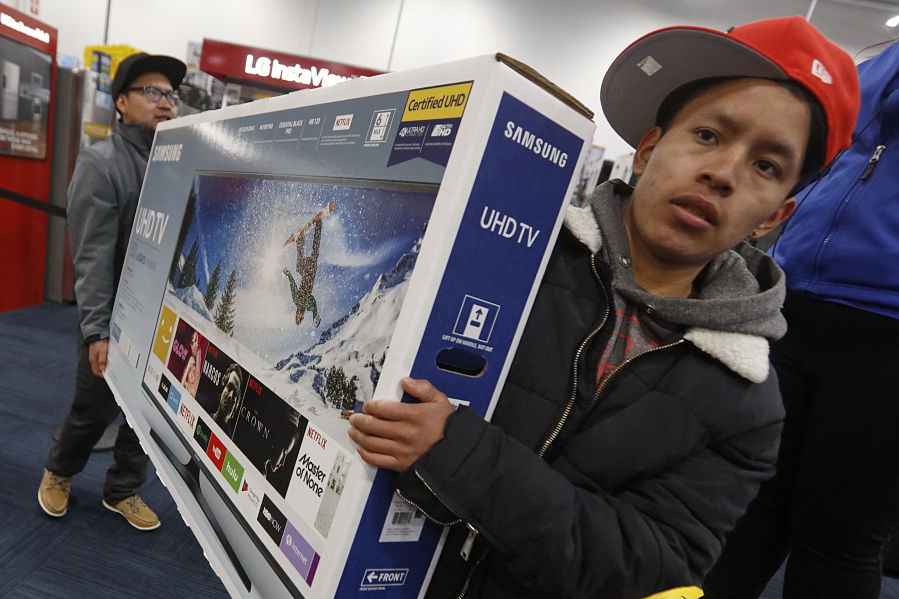 Shoppers wait to make purchases at a Best Buy on Black Friday in Dartmouth, Mass., Friday, Nov. 24, 2017.