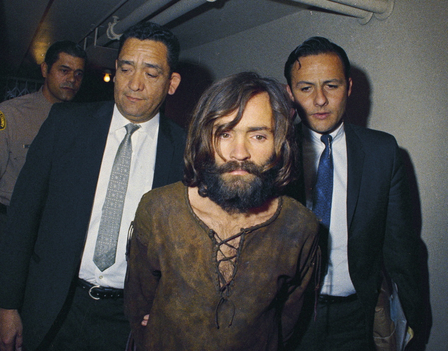 Charles Manson is escorted to his 1969 arraignment on conspiracy-murder charges in connection with the Sharon Tate murder case. Authorities say Manson, cult leader and mastermind behind 1969 deaths of actress Sharon Tate and several others, died on Sunday, Nov. 19, 2017. He was 83.