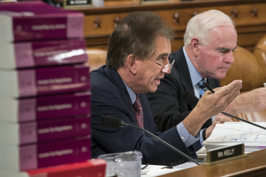 Rep. Jim Renacci, R-Ohio, joined at right by Rep. Pat Meehan, R-Pa., makes a point as the House Ways and Means Committee continues its debate over the Republican tax reform package, on Capitol Hill in Washington on Wednesday. (AP Photo/J.