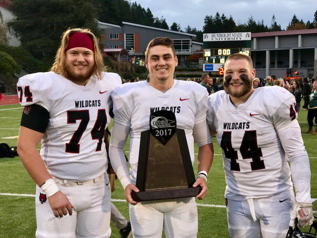 Central Washington football players Will Ortner (Hockinson), Reilly Hennessey (Camas) and Kevin Haynes (Battle Ground) proudly display the Great Northwest Athletic Conference trophy after 42-28 win at Humboldt State on Saturday to clinch the conference title.