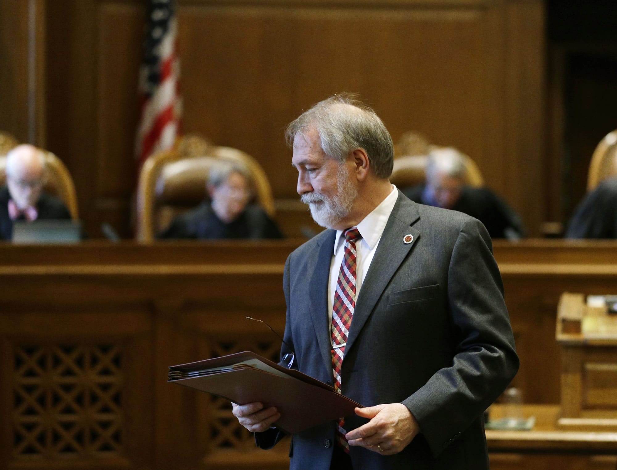 Alan Copsey, deputy solicitor general in the Washington state attorney general's office, during a Washington Supreme Court hearing last month in Olympia. The court ruled Wednesday that while lawmakers have made progress, they are not on track to meet a court-imposed deadline to fully fund basic education, and will remain in contempt of court.