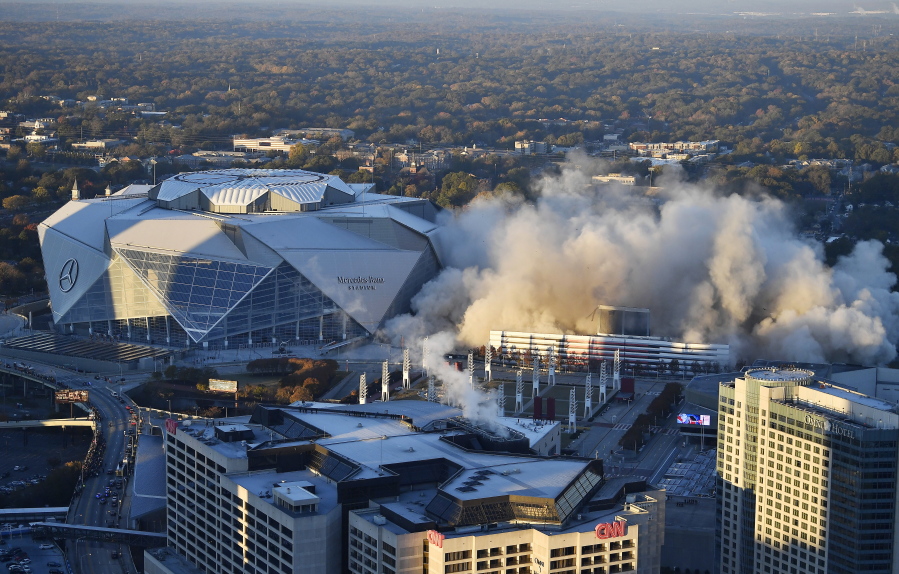 The Georgia Dome is destroyed in a scheduled implosion next to its replacement the Mercedes-Benz Stadium, left, Monday, Nov. 20, 2017, in Atlanta. The dome was not only the former home of the Atlanta Falcons but also the site of two Super Bowls, 1996 Olympics Games events and NCAA basketball tournaments among other major events.