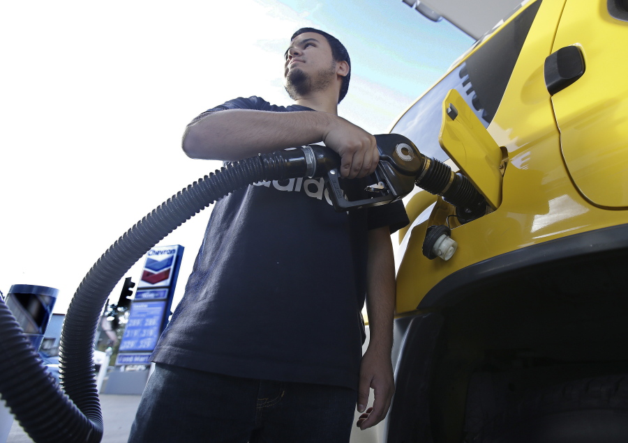 Cristian Rodriguez fuels his vehicle in Sacramento, Calif.