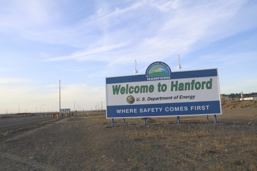 FILE - In this May 9, 2017 file photo, a sign welcomes drivers to Hanford Nuclear Reservation in Richland, Wash. After almost two decades of work, the government has nearly finished removing radioactive wastes from a first group of underground storage tanks in eastern Washington.