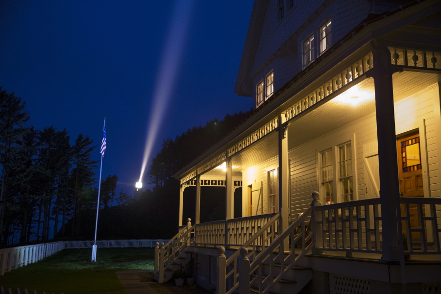 The light from the Heceta Head Lighthouse, left, shines over the nearby innkeepers house north of Florence, Ore. Oct. 25, 2017. The house has been turned into a bed and breakfast that is reportedly haunted by a ghost named Rue.