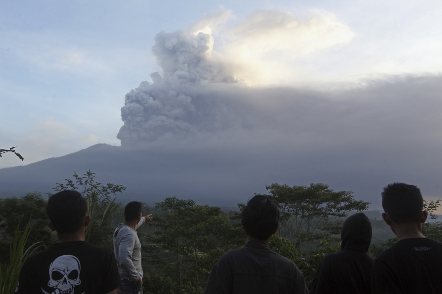 Villagers watch the Mount Agung volcano erupting in Indonesia.
