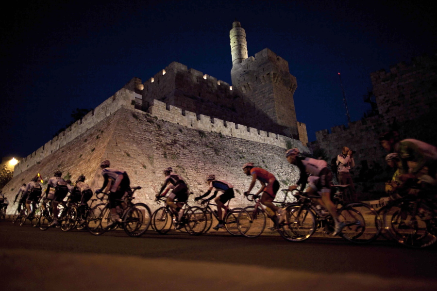 Cyclists from the Saxo Bank team ride past the walls of Jerusalem’s Old City during a race. The famed annual multi-stage bicycle race Giro d’Italia, or Tour of Italy, will make its start next May in Jerusalem under a longstanding tradition that some starts and stages of the race take place outside of Italy. Recognizing political sensitivities, the race will avoid Israeli-occupied West Bank, east Jerusalem and the historic Old City.
