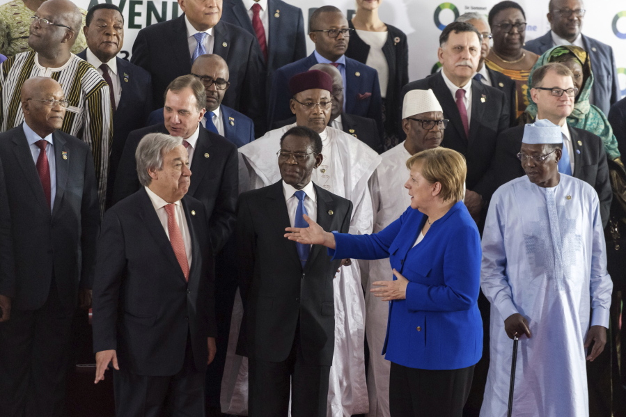 German Chancellor Angela Merkel, front right, speaks with United Nations Secretary General Antonio Guterres, front left, during a group photo at an EU Africa summit in Abidjan, Ivory Coast on Wednesday. German Chancellor Angela Merkel said Wednesday, during an EU-Africa summit, that the European Union wants to work more closely with Africa to address illegal migration.