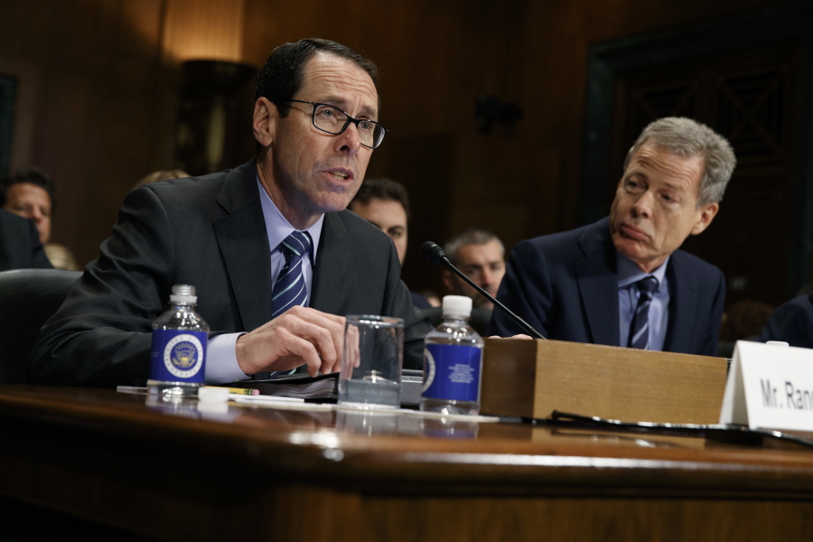 FILE - In this Wednesday, Dec. 7, 2016, file photo, AT&T Chairman and CEO Randall Stephenson, left, testifies on Capitol Hill in Washington, before a Senate Judiciary subcommittee hearing on the proposed merger between AT&T and Time Warner, as Time Warner Chairman and CEO Jeffrey Bewkes listens at right. The Justice Department intends to sue AT&T to stop its $85 billion purchase of Time Warner, according to a person familiar with the matter who was not authorized to discuss the matter ahead of the suit’s official filing.