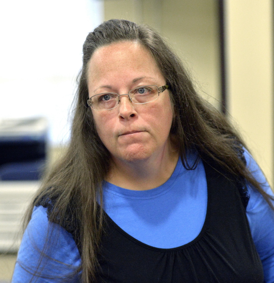 Rowan County Clerk Kim Davis listens to a customer at the Rowan County Courthouse in Morehead, Ky. Elwood Caudill says he plans to run for county clerk against Davis, who caused an uproar in 2015 when she refused to issue marriage licenses because of her opposition to same-sex marriage. Caudill ran against Davis in 2014 in the Democratic primary, but lost by 23 votes. In 2018, Caudill will run as a Democrat while Davis has switched parties to become a Republican. (AP Photo/Timothy D.