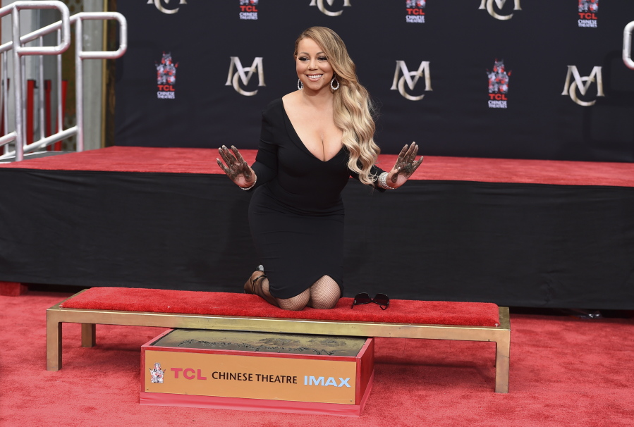 Mariah Carey poses for photographers during her hand and footprint ceremony at the TCL Chinese Theatre in Los Angeles. Carey, the artist with the most No. 1 hits on the Billboard Hot 100 chart, is one of the nominees for the 2018 Songwriters Hall of Fame.