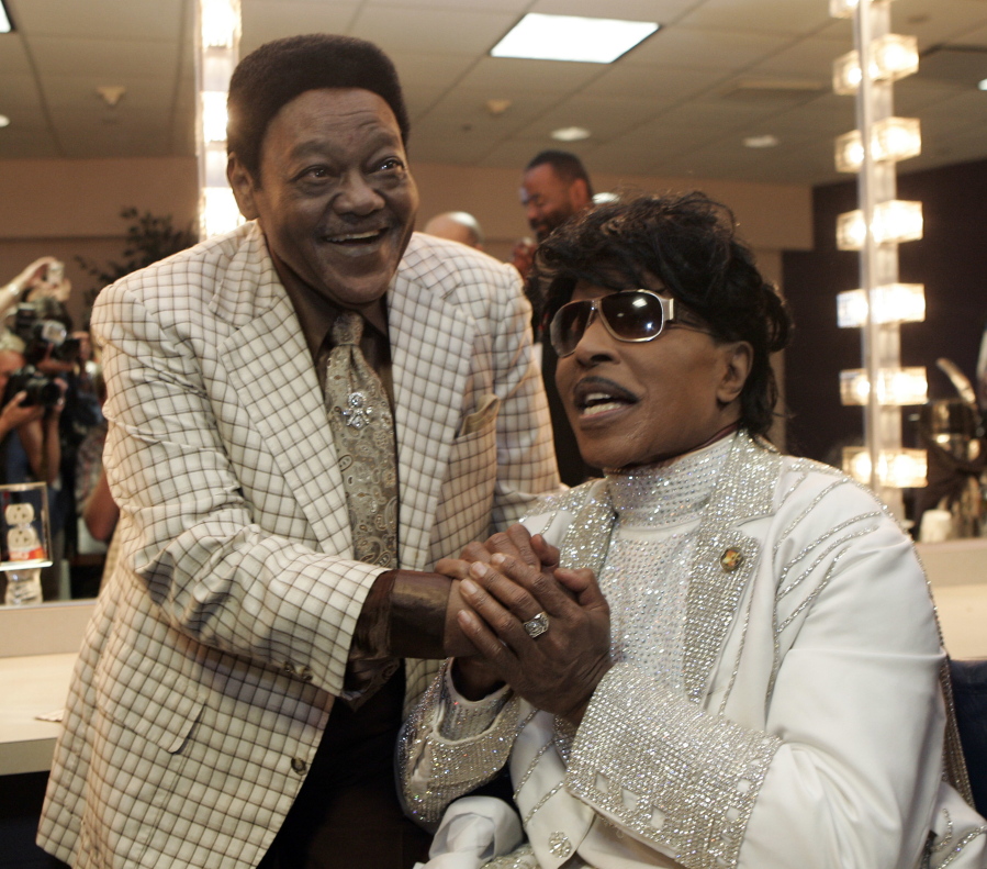 FILE - In this May 30, 2009 file photo, Fats Domino visits with Little Richard in a dressing room after Richards’ performance at The Domino Effect, a tribute concert for Domino, at the New Orleans Arena in New Orleans. Domino, the amiable rock ‘n’ roll pioneer whose steady, pounding piano and easy baritone helped change popular music even as it honored the grand, good-humored tradition of the Crescent City, has died. He was 89. Mark Bone, chief investigator with the Jefferson Parish, Louisiana, coroner’s office, said Domino died Tuesday, Oct. 24, 2017.