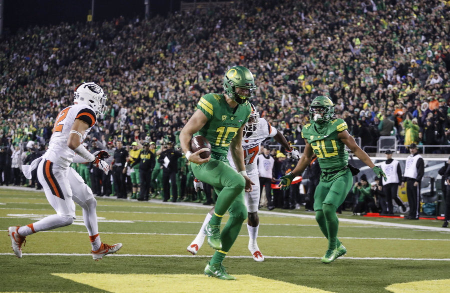 Oregon quarterback Justin Herbert (10), scores a touchdown untouched in the second quarter against Oregon State in an NCAA college football game Saturday, Nov. 25, 2017 in Eugene, Ore.