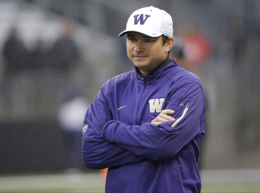 In this Saturday, Nov. 7, 2015 file photo, Washington offensive coordinator and quarterbacks coach Jonathan Smith looks on during warmups before an NCAA college football game against Utah in Seattle. A person with direct knowledge of the decision says Oregon State has hired Washington co-offensive coordinator Jonathan Smith to be its new head coach. The person spoke to The Associated Press on Wednesday, Nov. 29, 2017 on condition of anonymity because an official announcement was being finalized. (AP Photo/Ted S.