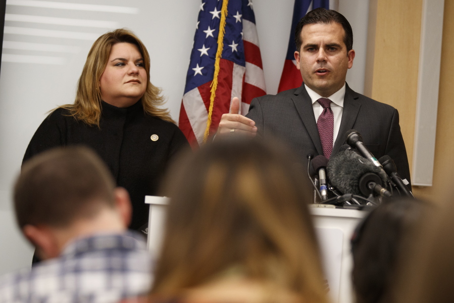 Resident Commissioner Jenniffer Gonzalez-Colon, who represents Puerto Rico as a nonvoting member of Congress, listens Monday as Puerto Rico Gov. Ricardo Rossello speaks during a news conference to urge Congress to include Puerto Rico in the Supplemental Disaster Relief Package in Washington.