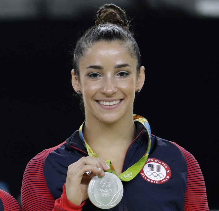 FILE - In this Aug. 16, 2016, file photo, United States’ Aly Raisman shows off her silver medal after the artistic gymnastics women’s apparatus final at the 2016 Summer Olympics in Rio de Janeiro, Brazil. Six-time Olympic medal winning gymnast Aly Raisman says she is among the young women abused by a former USA Gymnastics team doctor. Raisman tells “60 Minutes” she was 15 when she was first treated by Dr. Larry Nassar, who spent more than two decades working with athletes at USA Gymnastics but now is in jail in Michigan awaiting sentencing after pleading guilty to possession of child pornography.