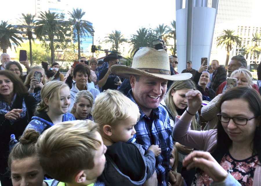 Ammon Bundy, center, a son of Nevada rancher and states’ rights figure Cliven Bundy, is greeted by family and friends at the U.S. District Courthouse in Las Vegas after being released from federal custody on Thursday. A federal judge ordered Bundy freed to house arrest during his trial on charges in an armed standoff with U.S. Bureau of Land Management agents near the Bundy ranch in Nevada.