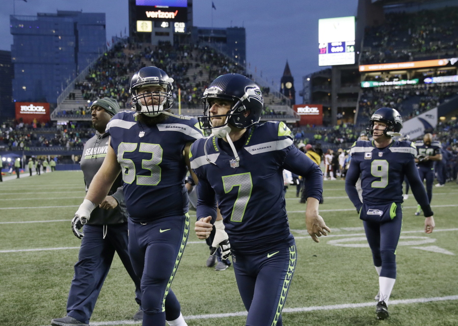 Seattle Seahawks kicker Blair Walsh (7) and offensive guard Mark Glowinski (63) walk off the field after an NFL football game against the Washington Redskins, Sunday, Nov. 5, 2017, in Seattle. Walsh missed on three field goal attempts and the Redskins won 17-14.