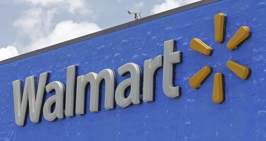 FILE - This Thursday, June 1, 2017, file photo, shows a Walmart sign at a store in Hialeah Gardens, Fla. Walmart announced Monday, Nov. 13, 2017, that it will devote a section on its website to upscale Lord & Taylor, the latest strategic partnership as retailers make alliances.
