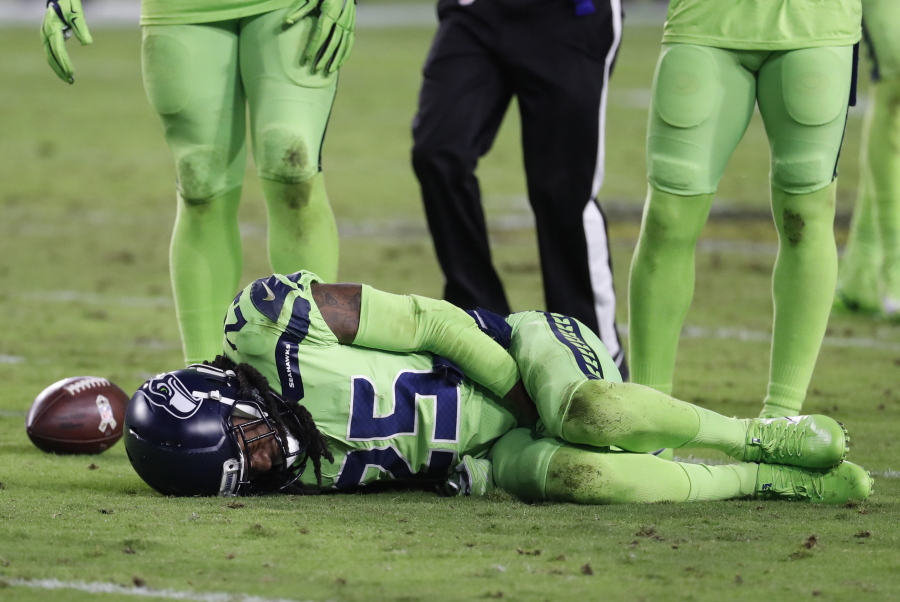 Seattle Seahawks cornerback Richard Sherman (25) lies injured on the turf after tackling Arizona Cardinals wide receiver John Brown (12) during the second half of an NFL football game, Thursday, Nov. 9, 2017, in Glendale, Ariz. Sherman did not return to the game after the injury.