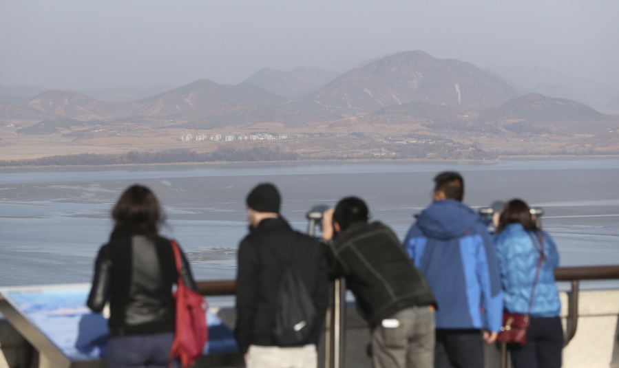 In this Nov. 14, 2017, photo, foreign visitors watch the North Korea side from the unification observatory in Paju, South Korea. South Korea says it will deport an American man detained for allegedly attempting to cross the mine-strewn border into North Korea.