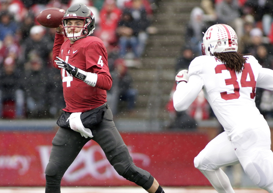 Washington State quarterback Luke Falk (4) throws a pass as he is chased by Stanford linebacker Peter Kalambayi (34) during the first half of an NCAA college football game in Pullman, Wash., Saturday, Nov. 4, 2017.