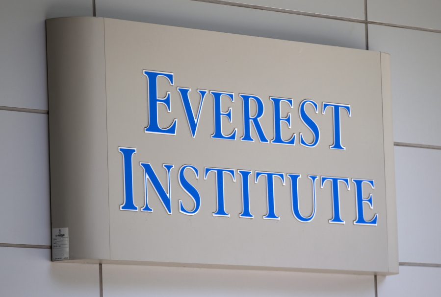 FILE - In this July 8, 2014 file photo, an Everest Institute sign is seen in a office building in Silver Spring, Md. Students who attended for-profit colleges filed more than 98 percent of the requests for student loan forgiveness alleging fraud by their schools, according to an analysis of Education Department data published Thursday, Nov. 9.
