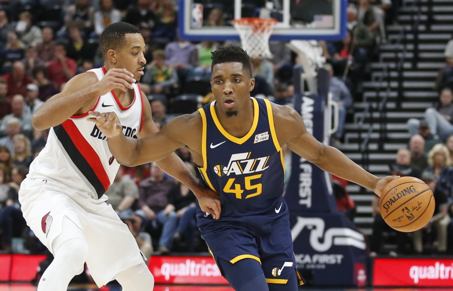 Portland Trail Blazers guard CJ McCollum, left, guards Utah Jazz guard Donovan Mitchell (45) as he drives in the first half during an NBA basketball game Wednesday, Nov. 1, 2017, in Salt Lake City.