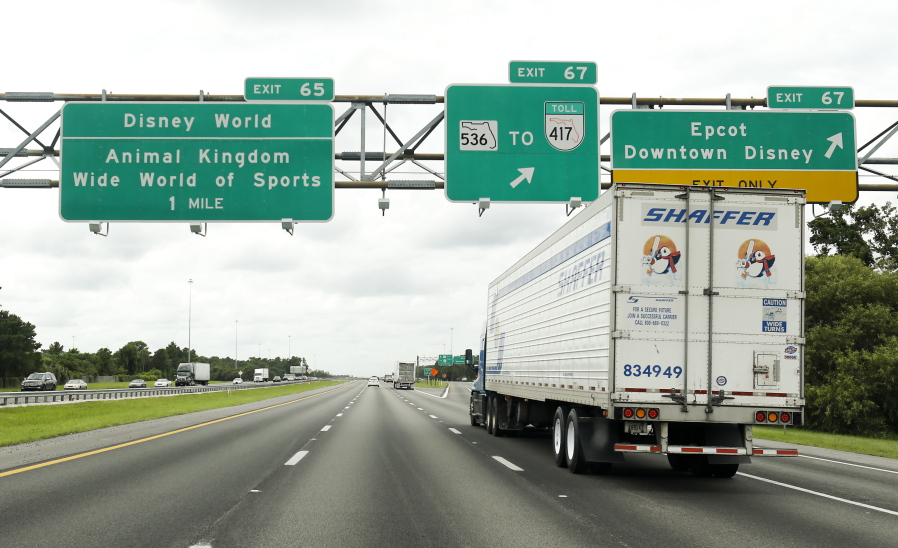 Traffic moves along Interstate 4 near Walt Disney World in Orlando, Fla. VisitOrlando.com has travel specials online through Tuesday.
