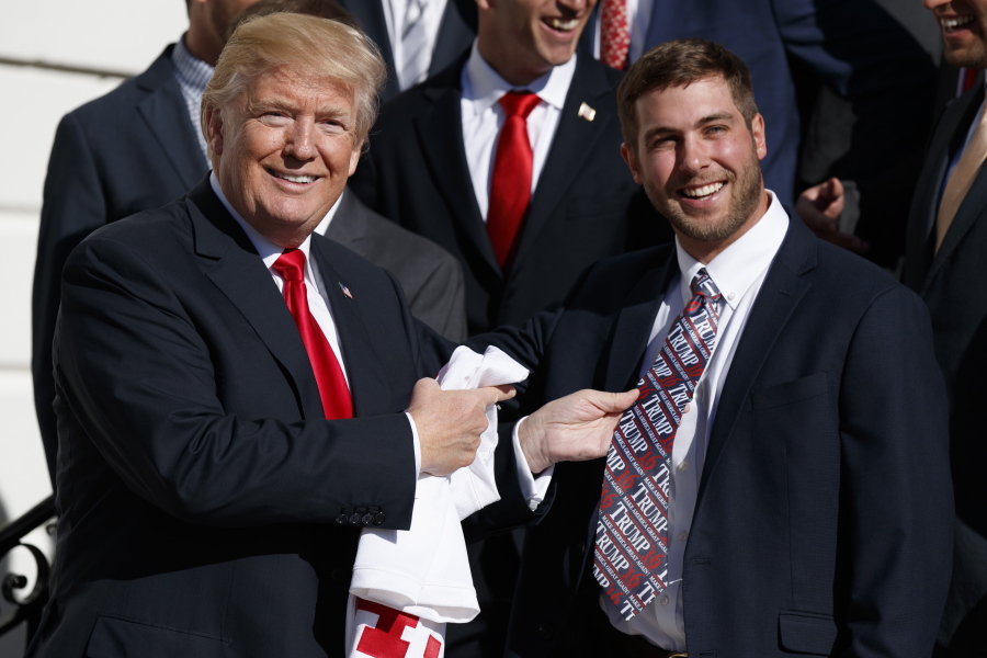 Maryland lacrosse player Dylan Maltz, of Ashburn, Va., shows off his tie to President Donald Trump as Trump meets with NCAA championship teams at the White House, Friday, Nov. 17, 2017, in Washington.