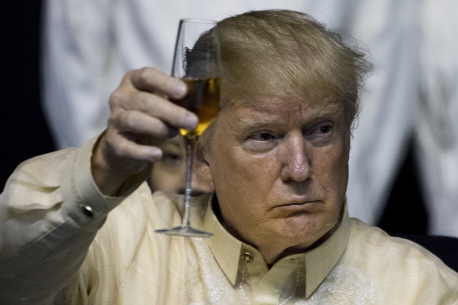 President Donald Trump holds up his glass as Philippines President Rodrigo Duterte gives a toast at an ASEAN Summit dinner at the SMX Convention Center, Sunday, Nov. 12, 2017, in Manila, Philippines. Trump is on a five country trip through Asia traveling to Japan, South Korea, China, Vietnam and the Philippines.
