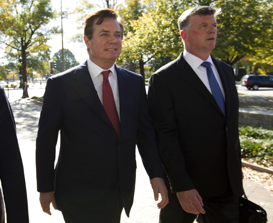Paul Manafort, left, accompanied by his lawyer Kevin Downing, arrives at Federal Court on Thursday in Washington.