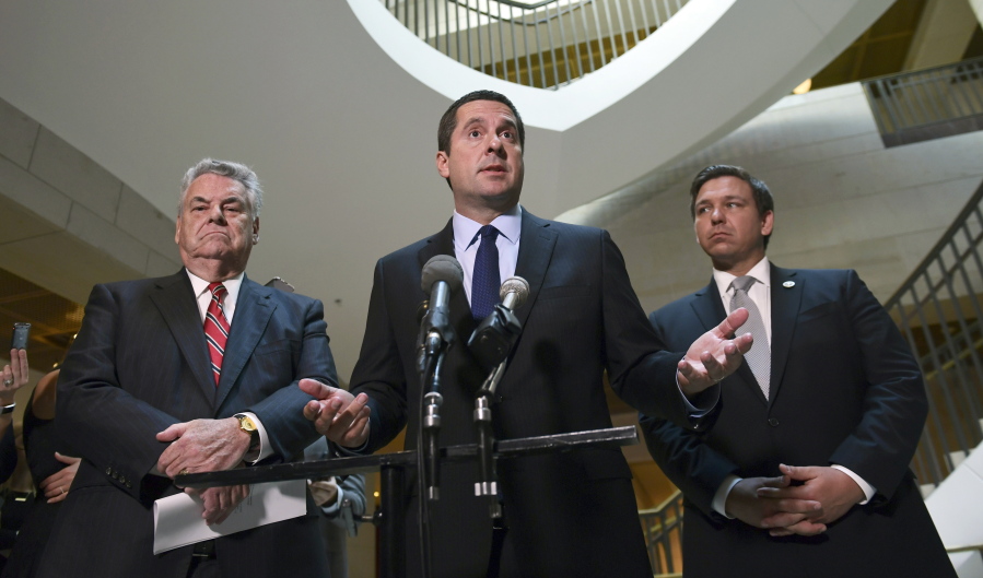 House Intelligence Committee Chairman Rep. Devin Nunes, R-Calif., center, standing with Rep. Peter King, R-N.Y., left, and Rep. Ron DeSantis, R-Fla., right, speaks on Capitol Hill in Washington. As Congress returns from its Thanksgiving break, some Republicans would like to wrap up investigations into Russian meddling in the 2016 election that have dragged on for most of the year. But with new details in the probe emerging on an almost daily basis, that timeline seems unlikely.
