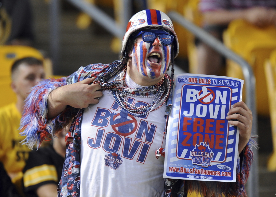 A Buffalo Bills fan displays a shirt and a sign in protest of Jon Bon Jovi’s interest in the Buffalo Bills, on Aug. 16, 2014 during an NFL preseason football game between the Bills and Pittsburgh Steelers in Pittsburgh. GQ magazine reported in October 2017 that Trump was behind a campaign that kept Bon Jovi from purchasing the Buffalo Bills NFL team in 2014.