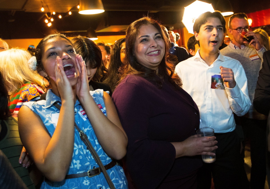 Manka Dhingra, center, Democratic candidate for state Senate, celebrates with supporters after taking an early lead Tuesday at an election night gathering in Woodinville.
